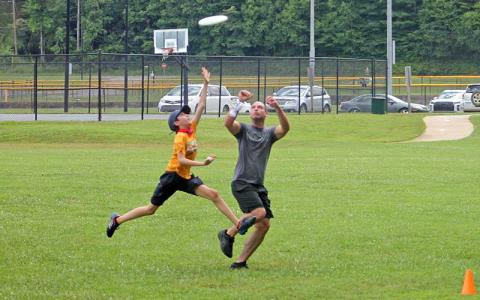 Press photo/Will Woolever - Appalachian Ultimate Frisbee Club members Elijah Moore (left) and Chris McConnell track a frisbee into the end zone at Parker Meadows July 13. 