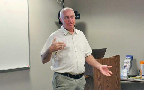 Press photo/Shelby Powell - County Manager Warren Cabe speaks at the Eggs and Issues business forum on Aug. 1 at the Chamber of Commerce. 