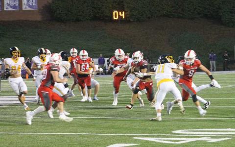 Press photo/Will Woolever - Sophomore fullback Garrett Young (right) carries the ball versus Murphy in Franklin’s season opener at Western Carolina University Aug. 22. Young racked up 125 yards on 27 attempts against the Bulldogs. 