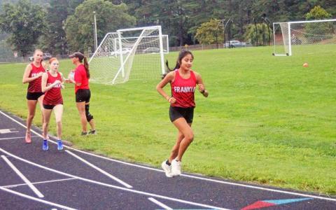 Press file photo - (From left) Abigail Pope, Mindi Holbrooks and Amy Mendoza Lopez are pictured in Franklin’s season-opening meet at Macon Middle School Aug. 13.
