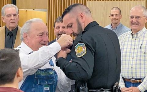 Press file photo - Former Sheriff Homer Holbrooks pins the sheriff’s badge on his son, Brent, following his election in 2022.