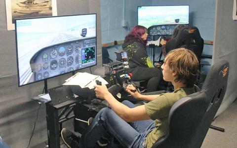Press photo/Shelby Powell - Franklin High School students enrolled in the aviation program use flight simulators housed in the old terminal building at the Macon County Airport.
