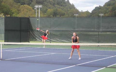 Press photo/Will Woolever Clara Stork serves while Marlee Barnes guards the net in the 5A West Pre-Regional Oct. 7.