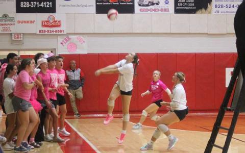 Press photo/Will Woolever - Franklin’s student section backs away as junior Sadie Green keeps a ball in play versus North Henderson Sept. 30. 