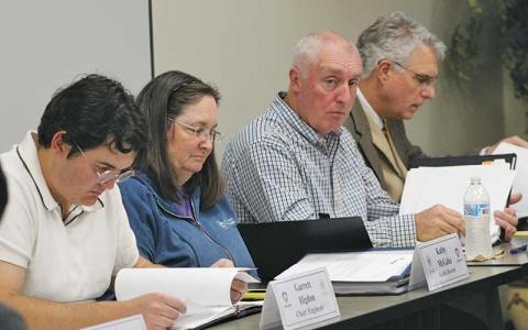 Press photo/Shelby Powell - Board of Health chair Garrett Higdon, Public Health Director Kathy McGaha, County Manager Warren Cabe and county attorney Eric Ridenour review proposed policy changes at the Oct. 28 health board meeting. 