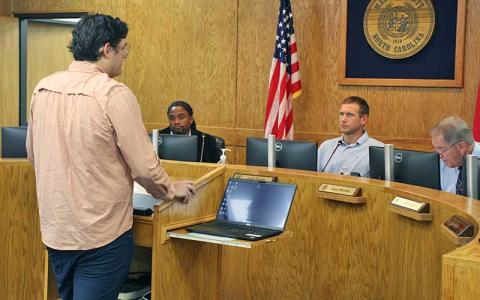 Press photo/Shelby Powell - Board of Health chair Garrett Higdon speaks to commissioners about the health board’s decision recommending consolidation between Macon County Public Health and Animal Services. 
