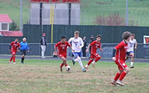 Press file photo - Sophomore Anthony Mora-Martinez keeps the ball away from West Henderson after being called up to the varsity team midway through the year.