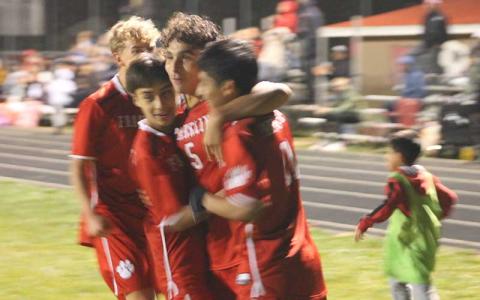 Press photo/Will Woolever - Junior Kevin Torres (second from right) celebrates with teammates after scoring in Franklin’s first-round playoff match versus North Buncombe.