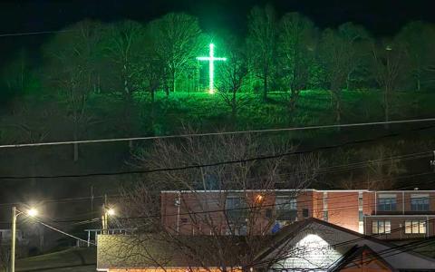 Press photo/Mia Overton - For 40 years the Sanders family has shared the Christmas spirit by lighting a cross on the hill overlooking East Franklin.