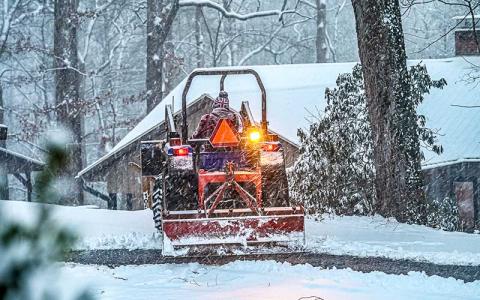 Photo/Bob Scott - John Bueck scraping Summit Drive in Franklin.