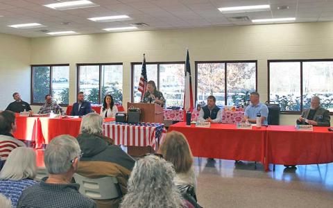 Press photo/Shelby Powell - Candidates at the commissioners forum (from left) District 2 candidates Nick Lofthouse, David Culpepper, Dylan Castle and Kellie Burns; Republican Party Chair Patti Trick at the microphone; and District 1 candidates John Shearl, Joey Wilson and Don Willis.