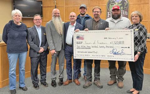 Press photo/Mia Overton - The Town of Franklin has received $4.3 million in federal funding for work at the water treatment plant. Pictured at the Feb. 7 check presentation are Town Council members Rita Salain, Travis Higdon, Jeff Berry, Mayor Stacy Guffey, Water Treatment Plant Supervisor Kyle Pocquette, Congressman Chuck Edwards, Public Works Director Bill Deal and Town Manager Amie Owens. 