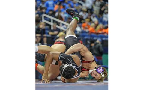 Photo courtesy of Josh Young - Garrett Young battles a wrestler from Havelock in the 5A State Quarterfinals at the Greensboro Complex Feb. 20.