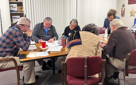 Press photo/Mia Overton - The Macon County Board of Elections members and Board of Elections Supervisor Melanie Thibault (standing) during Early Voting counting on March 3. Board members are (from left) Chair John Vanhook, Gary Dills, Kathy Tinsley, Paul Niskanen and Lynne Garrison
