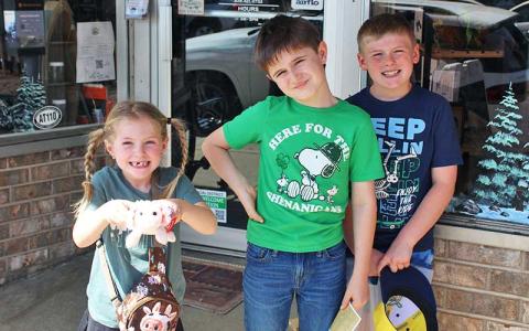 Press photo/Shelby Powell - Kyle Davidek, Caden Davidek and Cooper Creel walk around downtown Franklin looking for history to fill out their “Passport to the Past.” 