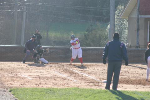 Press photo/Will Woolever. Taylor Carrion makes contact with a pitch in a freezing St. Patrick’s Day game versus East Henderson. 