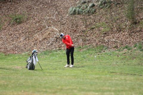 Press photo/Will Woolever. Braylen Dulicai chips from the first fairway at the Franklin Golf Course March 18. The ball is visible in the lower right.  