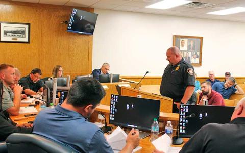 Press photo/Shelby Powell - Cowee Fire Chief Dustin Pendergrass speaks to Macon County commissioners to request funding for the department.