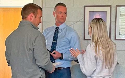 Press photo/Shelby Powell - Macon County Commissioner Chair Josh Young, Superintendent Josh Lynch and Macon County Schools finance officer Laney Ledford speak after a liaison meeting. 