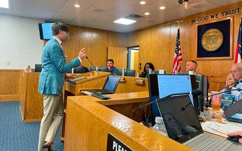 Press photo/Shelby Powell - Mitch Brigulio of Davenport and Company speaks with Macon County commissioners about the upcoming budget season. 