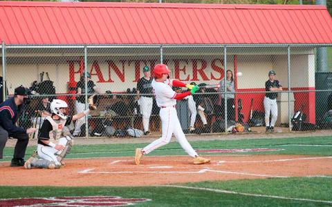 Will Rauers knocks a second-inning single versus East Henderson April 8. (Press photo/Will Woolever)