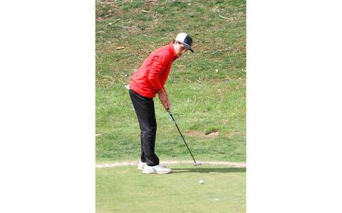 Freshman Reid Willis putts on the first green at the Franklin Golf Course March 18. (Press file photo)