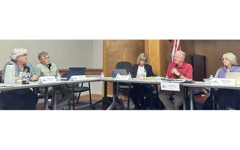 Highlander photo/Mitch Stone - FRL Board Chair Bill McGaha and Cynthia Womble discuss whether Swain County should receive a higher percentage of net surplus funds due to the free rent it has provided for FRL headquarters.