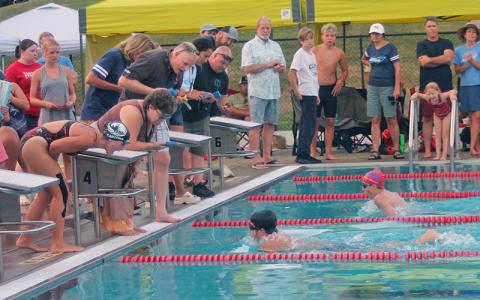 FAST's Michael Canzone (foreground) wins a close race with Highlands' Justin Powell in the 13-14 boys 100-yard breaststroke July 9. (Press photo/Will Woolever)