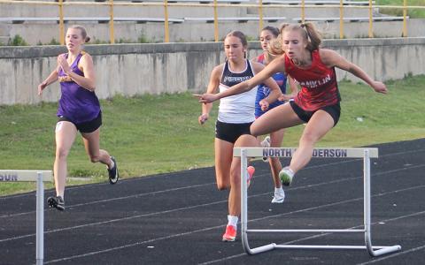 Anna Timan runs the 300-meter hurdles at the Mountain Eight Conference Championships April 30. Credit: Press file photo