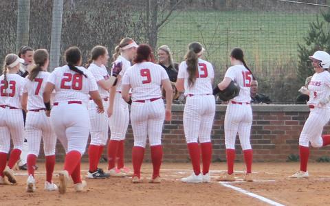 Alyssa Awtrey (right) is mobbed by teammates at home plate after belting a tw-run homer versus Murphy March 4. (Press file photo)