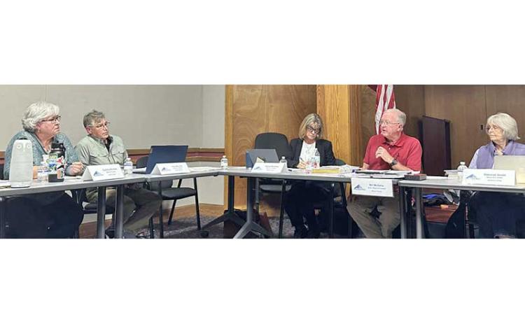 Highlander photo/Mitch Stone - FRL Board Chair Bill McGaha and Cynthia Womble discuss whether Swain County should receive a higher percentage of net surplus funds due to the free rent it has provided for FRL headquarters.