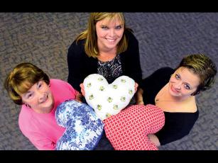 Press photo/Linda Mathias  - Breast cancer survivors in Macon County are sewing heart shaped drainage tube pillows for current patients. From left: Rita McElroy, Lori Smith, Gwen Bradley-Stanfield.
