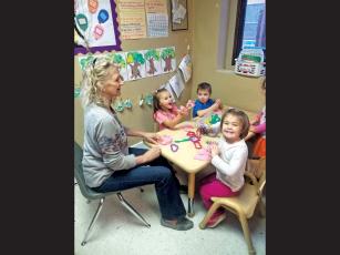 Photo submitted Bonnie Berk and her 3-year-old foster “grandchildren” at Long’s Chapel UMC in Waynesville.