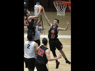 Press file photo - Franklin’s two Treys – Penland (23) and Woodard (10) – reach for a rebound in a November scrimmage against Andrews. Penland, a sophomore, scored 13 points Saturday in his first career varsity start. 