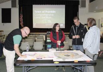 Press photo/Jake Browning - Greg Mullins, Jen Seymour, Greg Seymour and Stacy Mullins review a town map at the comprehensive land use plan meeting.