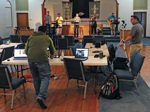 Photo submitted - Daniel Rogers, left, and Lee Cloer work the computers during a live-streamed  service at Holly Springs Baptist Church. On stage, from left, are Matt Corbin, Kelly Corbin, Kathi Graham and Katie LaFlamm.