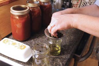 Press photos/Will Woolever - Laura Gamble revived a family tradition this year when she began canning vegetables from her home garden.