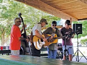 Photo submitted - Local musicians (from left) Ron Van Beuning, Chuck Dorling, Jay Baird, Dave Stewart play a concert under the Big Bear shelter at the Little Tennessee River Greenway recently. For the past few months Macon Music has hosted weekly music gatherings at the greenway.