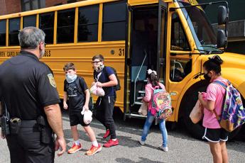 Press photo/Linda Mathias - Tom Pruett, school resource officer at East Franklin Elementary, watches as students board buses.