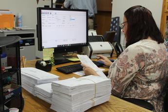 Press photo/Jake Browning - Judy Fritts with the Macon County Elections Office inputs the names of voters whose absentee ballots have already been received. As of Monday, Oct. 12, the elections office had received 4,319 requests for absentee ballots and had 2,173 completed ballots returned. 