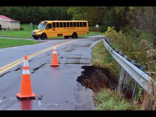Press photo/Linda Mathis - A school bus takes a detour around a damaged section of Wells Grove Road.