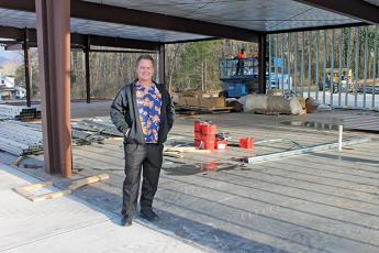 Press photo/Lee Buchanan - Smart Pharmacy owner Jacob Reiche stands at the site of his store’s future location at the Wayah Street/Maple Street roundabout.