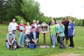 Read2Me held a dedication for the newest Little Free Library on May 18 at Macon Middle School. The library was dedicated in honor of long-time educator Clayton Ramsey. Pictured are members of Friends of the Library, Rotary of Franklin, Macon County Library staff, Clayton Ramsey’s family, Read2Me and Macon Middle School. (Front, from left) Lenny Jordan, Sally Dyar, Matthew Vargas, Laura Vargas and Janet Greene; (back row) Mike White, Tom James, Karen Wallace, Sharon and Jeff Gillette, Bill Swift, Debbie Tall