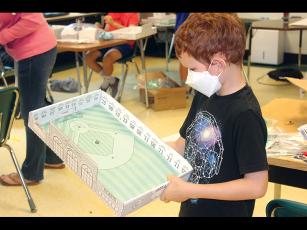 Press photo/Jake Browning - Keegan McKinley with a game board he designed himself as part of Camp Invention.