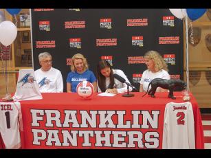 Press Photo/Will Woolever - FHS senior and volleyball standout Amy Tippett signs her official offer from UNC-Asheville as dad Steve, sister Brooke, and mom Kelli look on.