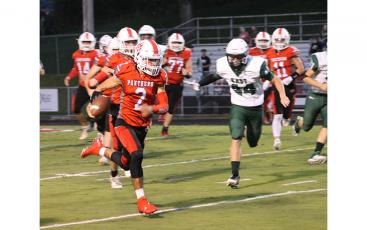 Press Photo/Will Woolever - Senior quarterback Chris McGuire outruns East Henderson defenders in the first quarter of their Sept. 17 blowout win. McGuire would score a 41-yard touchdown on the play. 