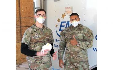 Press photo/Eric Braham- Specialist Ryan Nizolek and Staff Sgt. Hampton with the National Guard help distribute free N95 masks at the Macon County Health Department. Masks may be picked up in the drive-thru COVID testing lane in front of the jail on Lakeside Drive. To avoid wait times, do not go to pick up masks on Wednesdays when they are giving vaccines. To request a mask pick-up time, call 828-349-2081. 