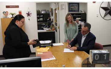 Press photo/Will Woolever Rep. Karl Gillespie files to run for re-election on Tuesday morning as his wife Janet and election specialist Judy Fritts look on.