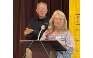 Photo submitted Tax Administrator Abby Braswell and Commissioner Gary Shields speak during the program at the Rotary Club of Franklin meeting on Aug. 10