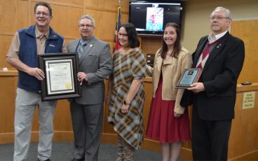 Press photo/Mia Overton   Sen. Kevin Corbin (left) presented retiring Police Chief Bill Harrell the Order of the Long Leaf Pine award. Harrell is pictured with his family and Mayor Jack Horton, who presented Harrell with a plaque of appreciation.